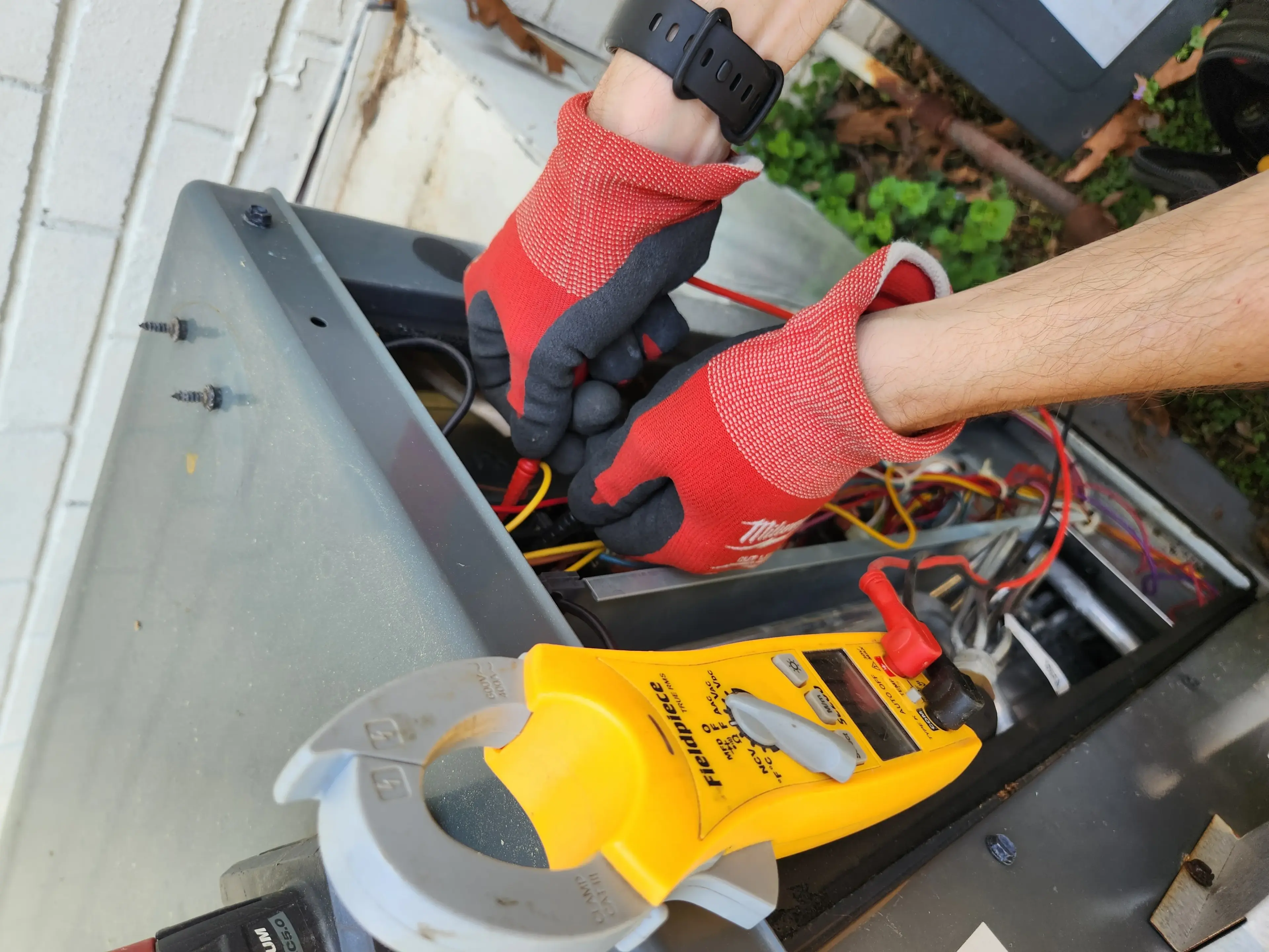 Technician inspecting an HVAC air filter during a maintenance visit in North Carolina